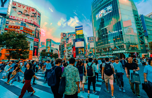 group of people crossing at the pedestrian lane surrounded by buildings
