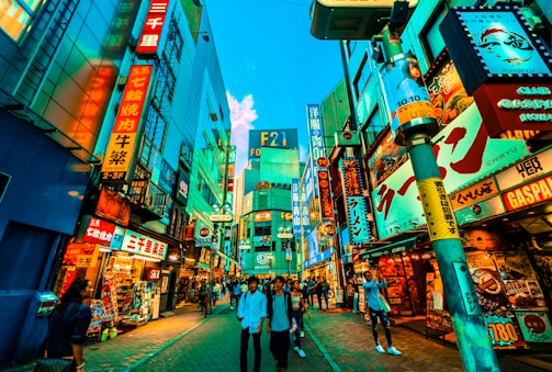 A vibrant street scene in Tokyo bustling with colorful signs and lively crowds.