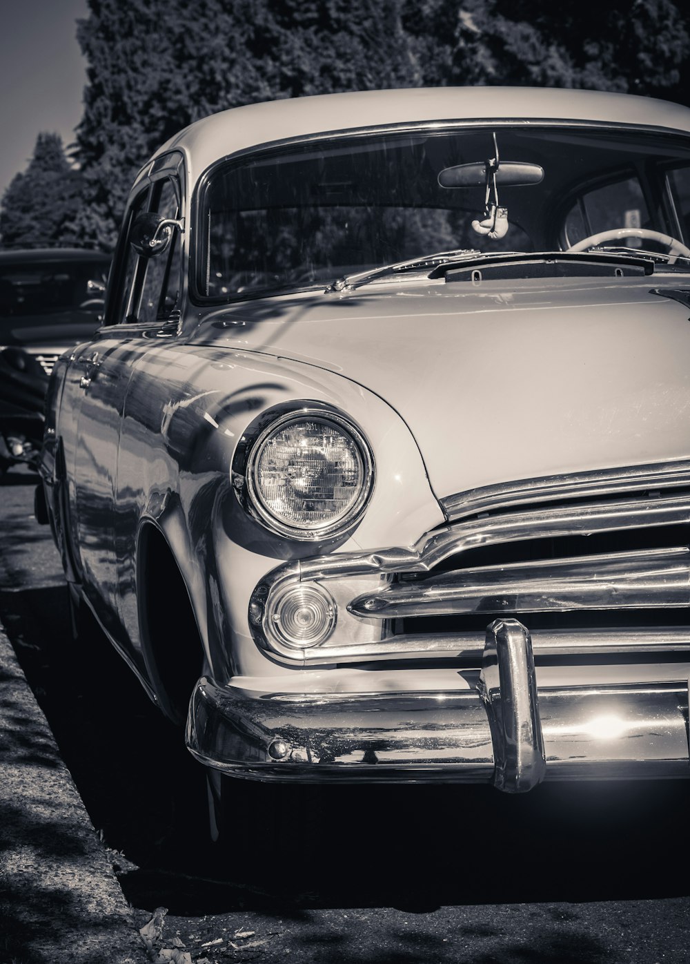 a black and white photo of a classic car