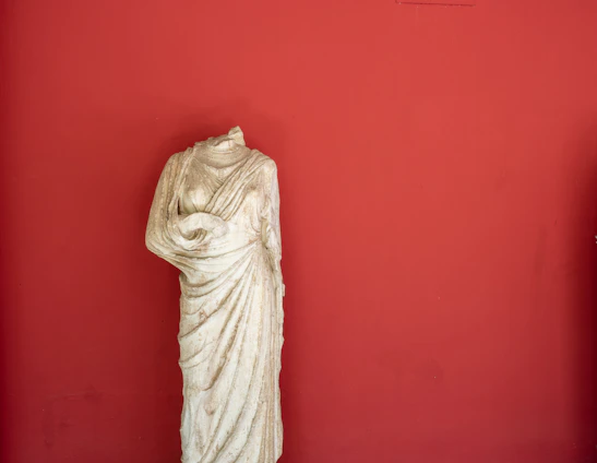 A marble-textured background with golden accents framing portraits of Plato and Aristotle inspired by Raphael's School of Athens.