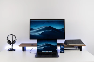 A minimalist desk setup featuring a notebook, headphones, and a tablet showing Islamic course content.