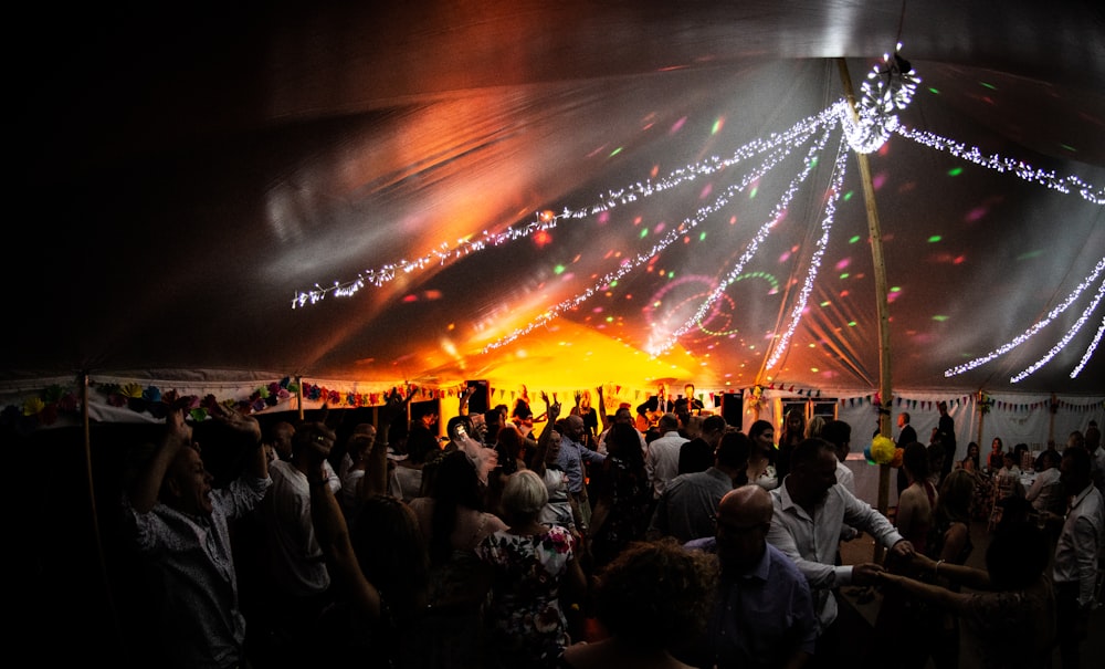 people dancing under black and white canopy