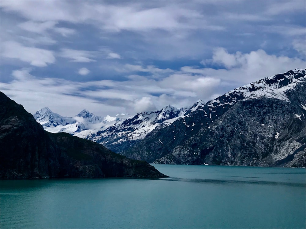 calm lake near glacier mountain during daytime