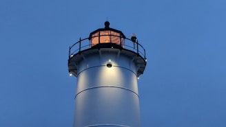 A serene lighthouse glowing warmly at dusk, symbolizing guidance and hope.