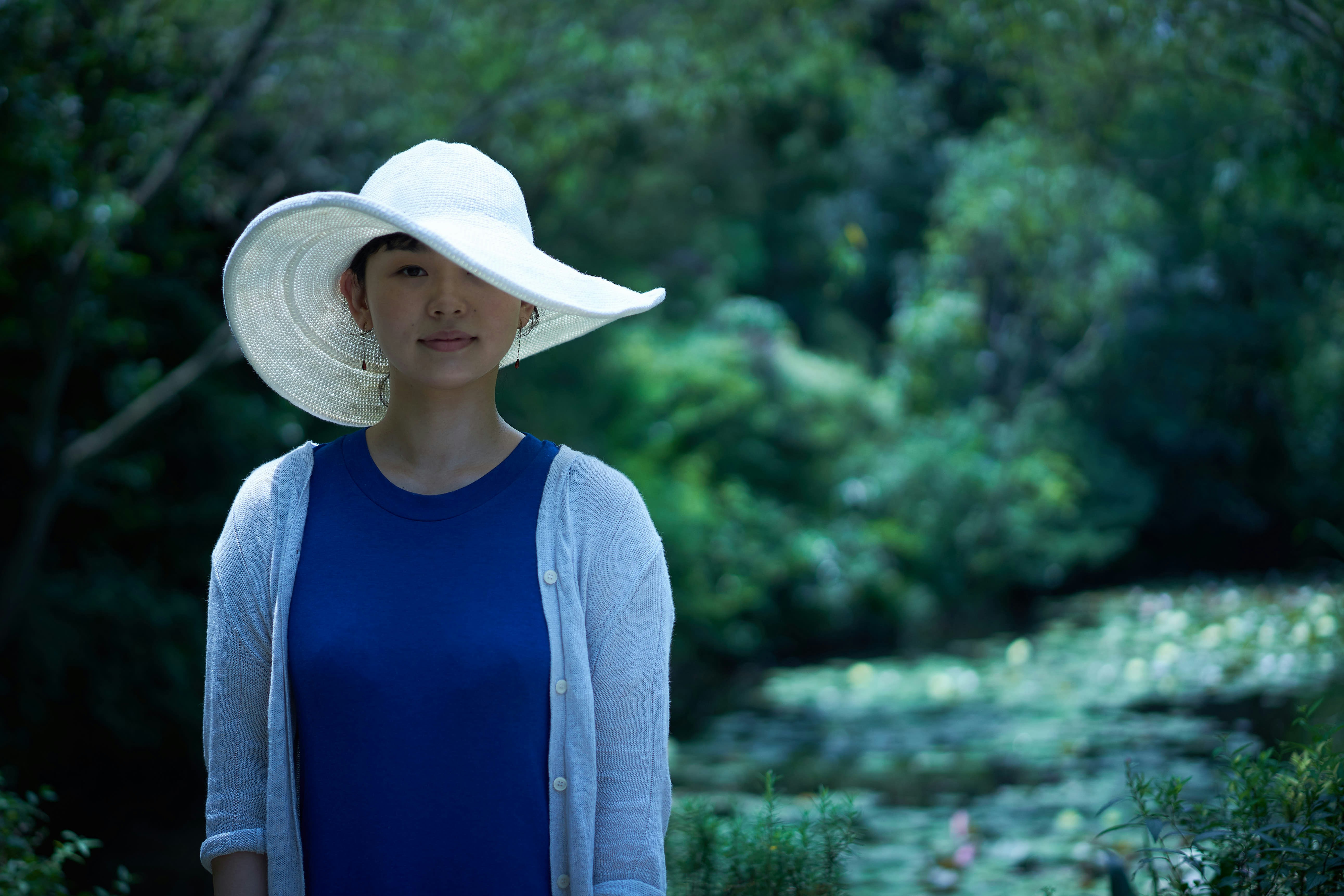 woman wearing sun hat and cardigan
