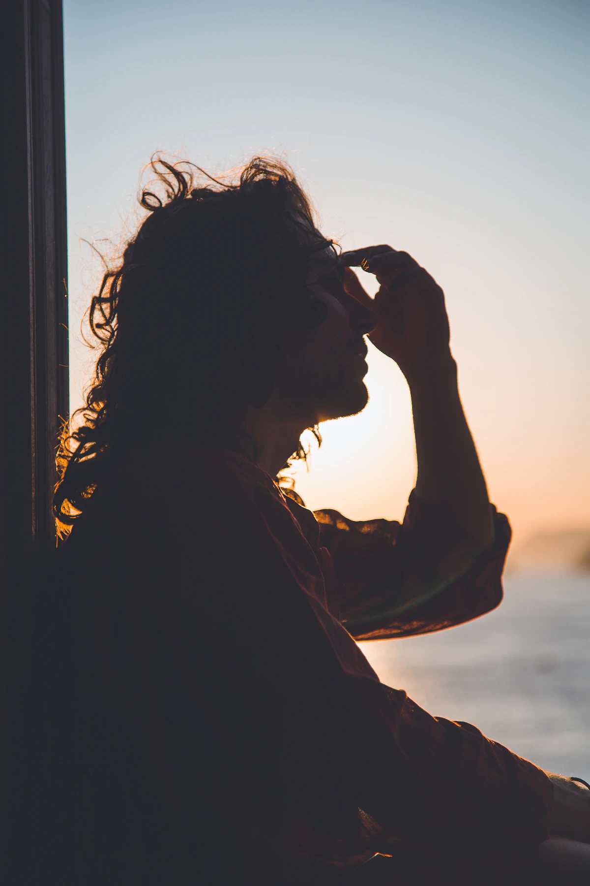 Man holding his forehead in pain, a common presentation of migraine