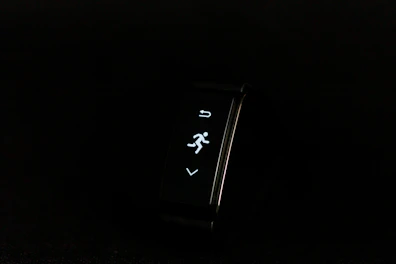 A compact wearable fitness tracker displaying health stats on the screen.