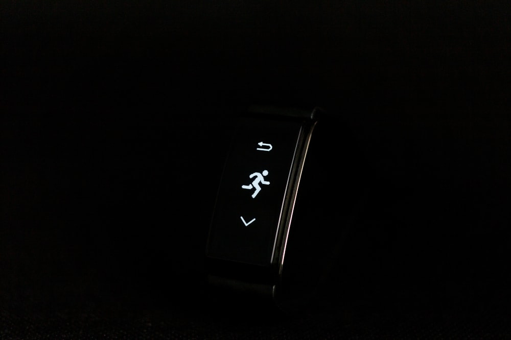 a close up of a watch on a black surface