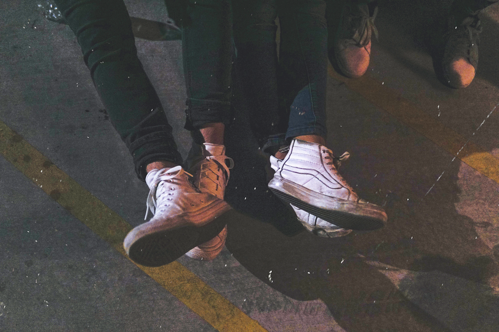 two persons wearing high-top sneakers