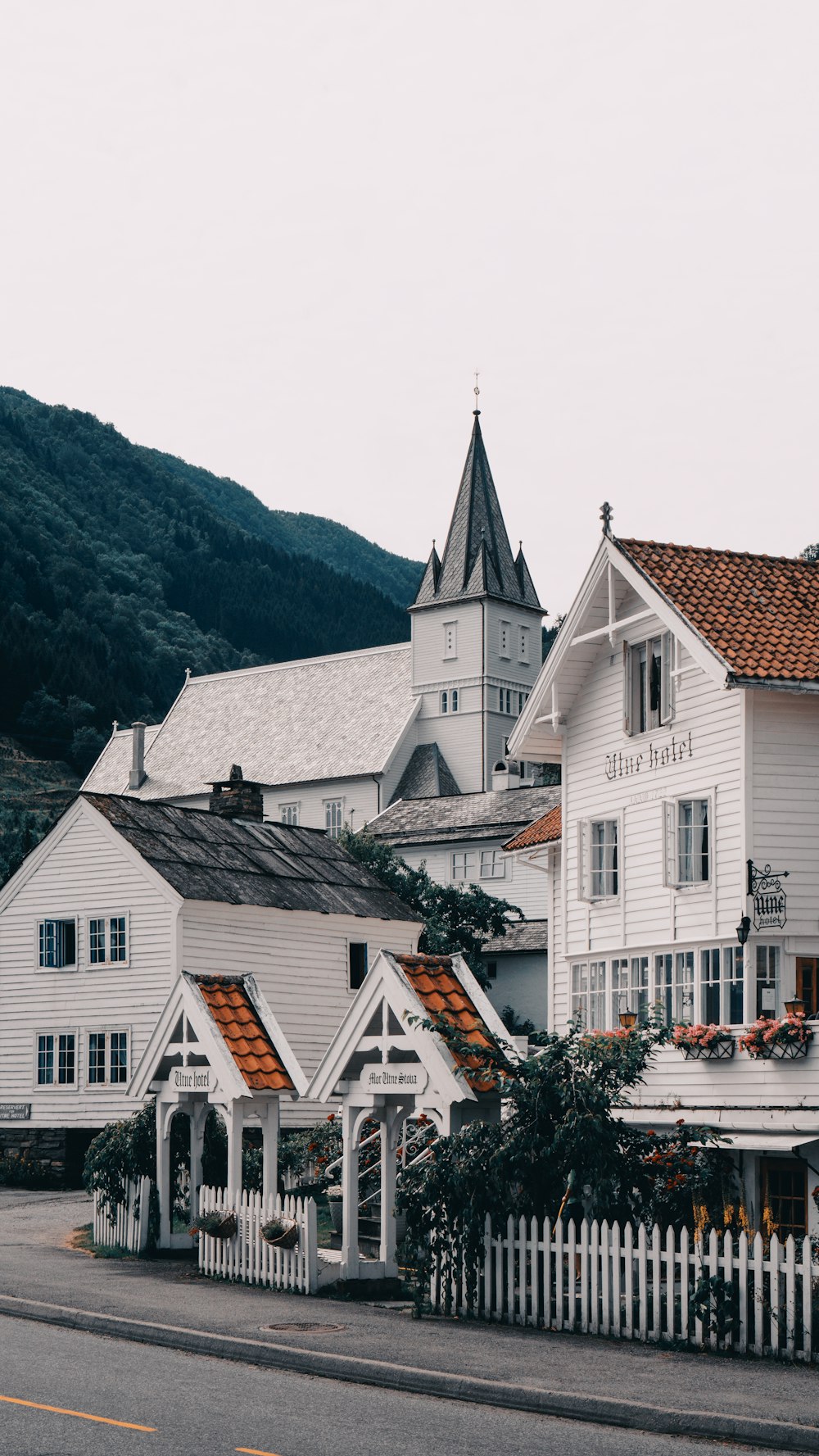 white concrete house near mountain at daytime