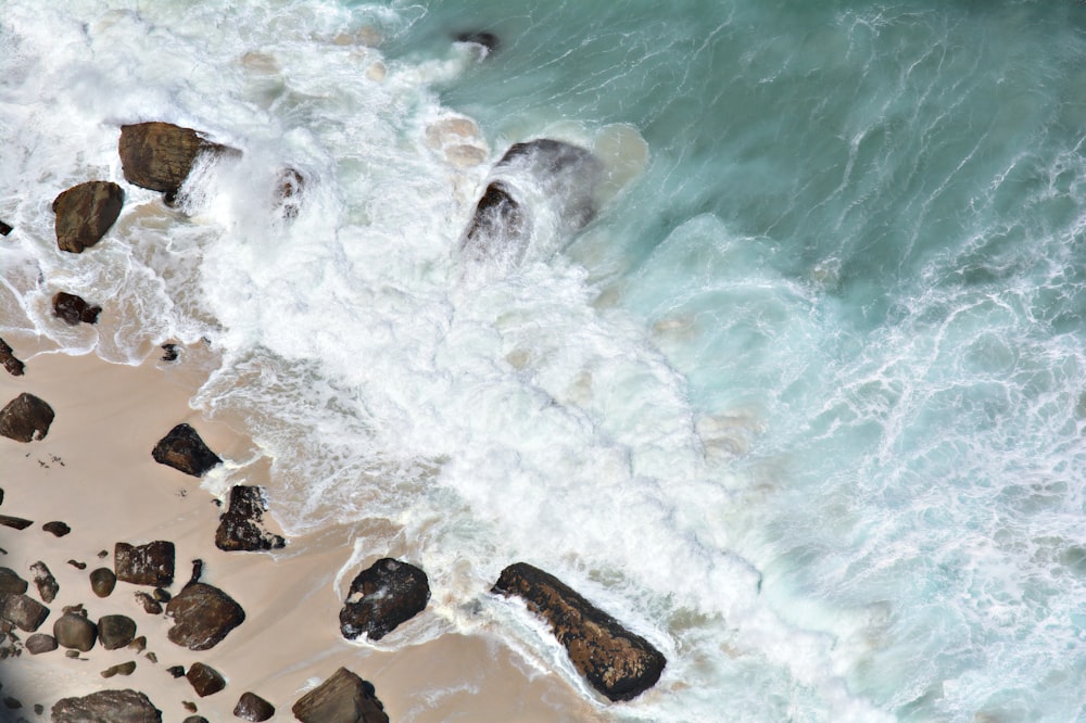 body of water splashing in a rock