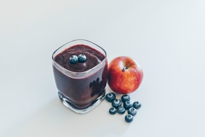 red apple on white surface plum pudding zoom background