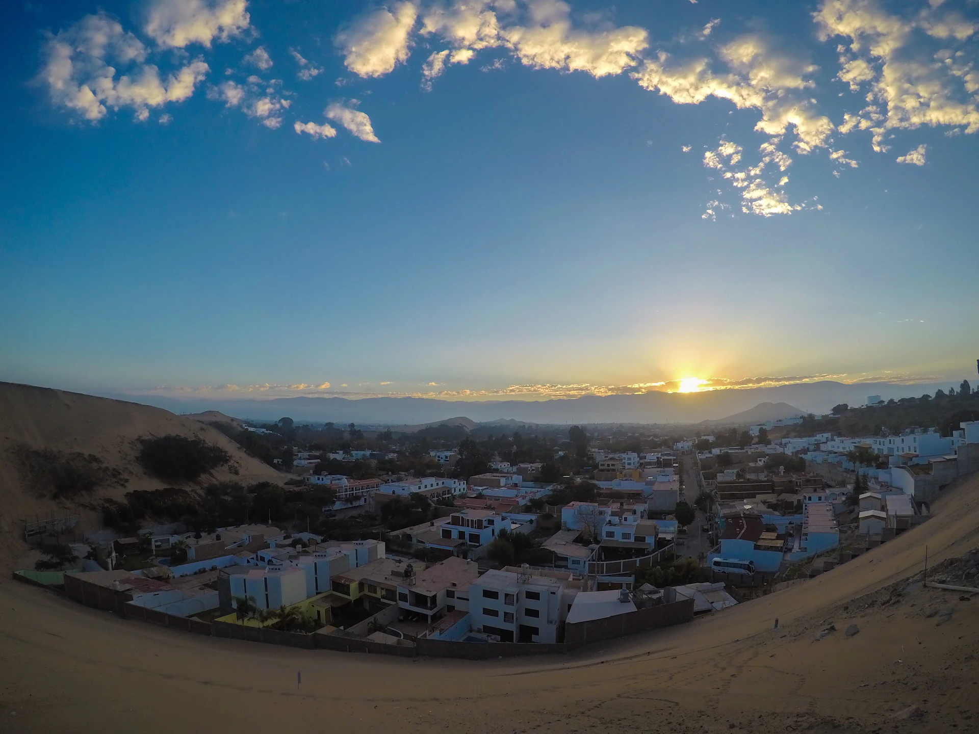 A panoramic view of a regional town at sunset, symbolizing the diverse stories and updates covered by pantaunusa.