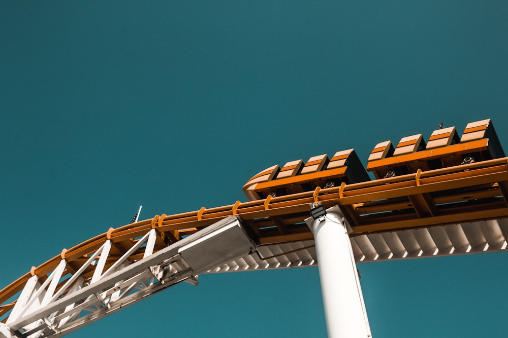 worm's-eye view of orange roller coaster