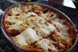 Golden baked lasagna fresh out of the oven, bubbling with cheese and herbs.