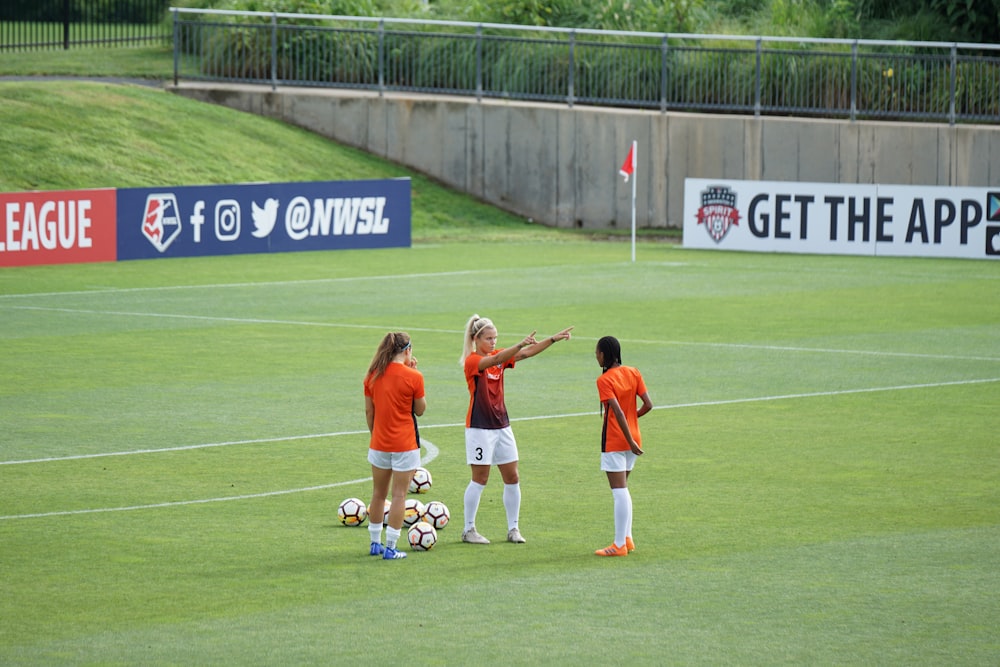 photo of woman standing on soccer field