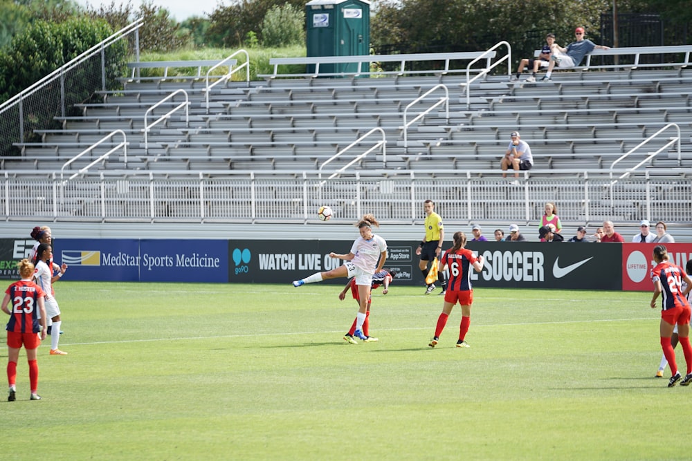 photo of woman kicking soccer ball