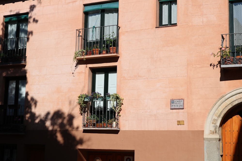 brown concrete building with plant pot during daytime