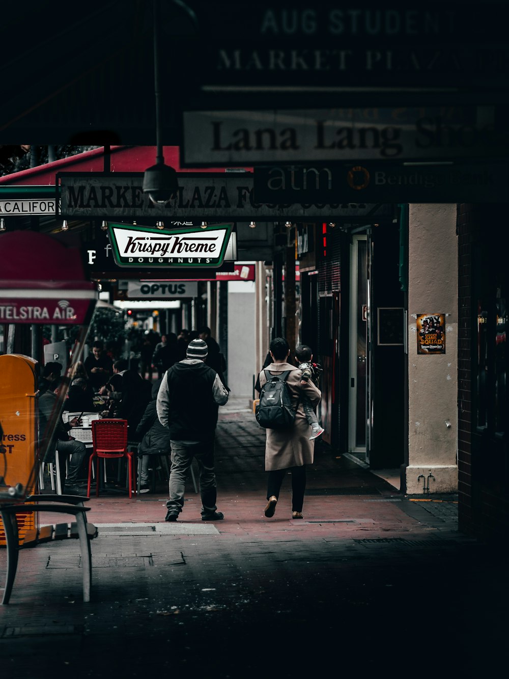 person standing in front of Krispy Kreme store