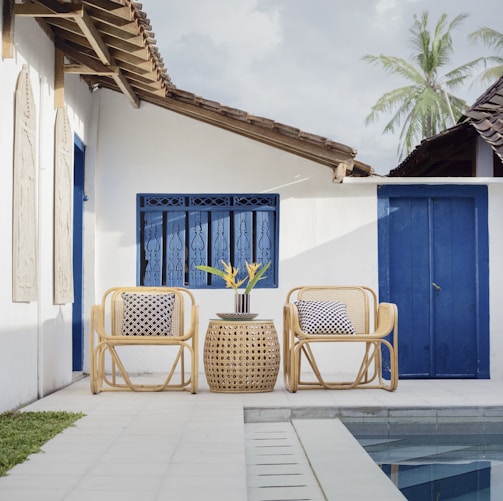 wicker table and two chairs near swimming pool