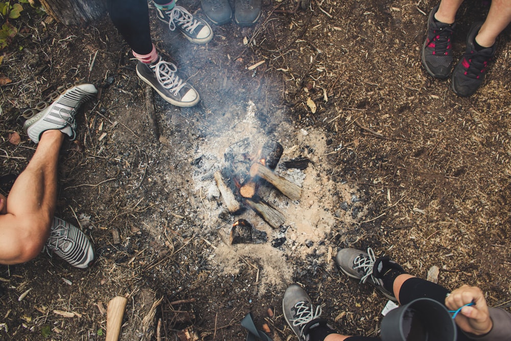 group of people surrounding bonefire