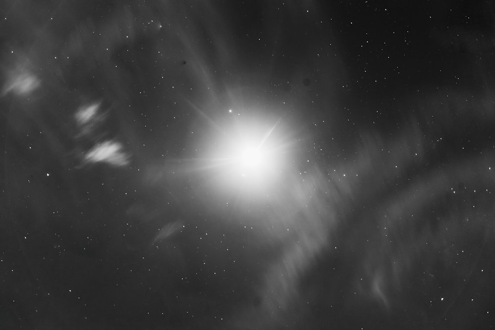 a black and white photo of the moon and stars