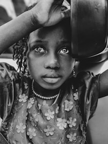 girl holding bowl on grayscale photography