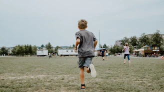 boy running on lawn