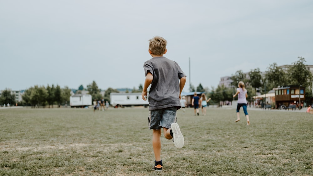 boy running on lawn