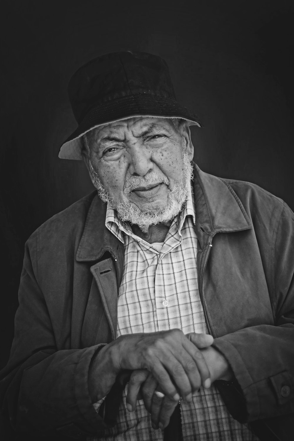 grayscale photo of man wearing jacket