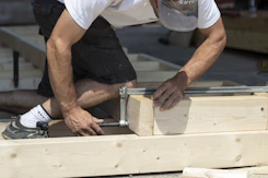man holding gray metal hand tool