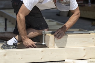 Construction worker installing a window frame on a building site.