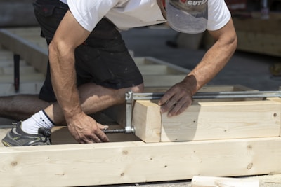 Close-up of hands assembling wood frame elements for a residential building