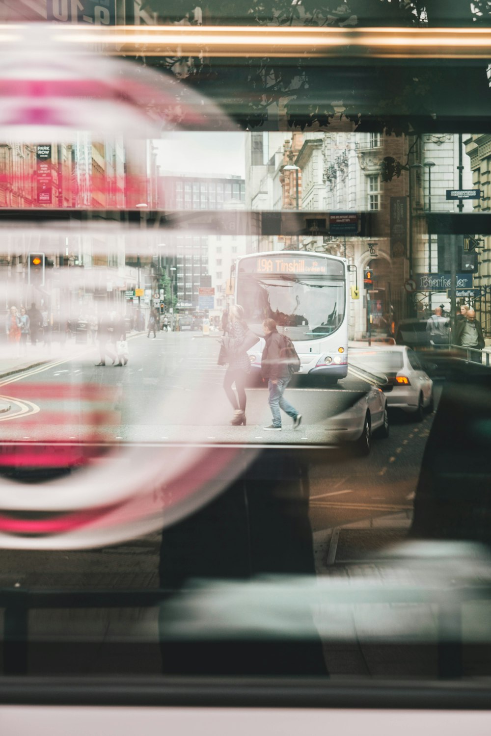 two person walking on road near bus