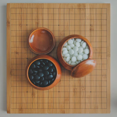 Close-up of a beautifully crafted gomoku board with polished wooden pieces in striking black and white.