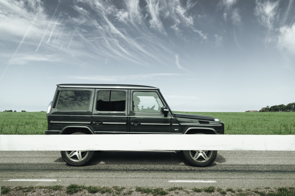 black SUV near green grass outdoors