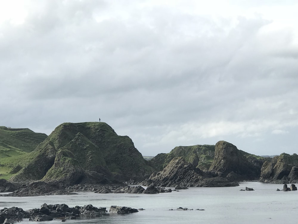 rock formation under gray cloudy sky