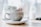 A stylish coffee jug placed on a wooden table with a cozy background.