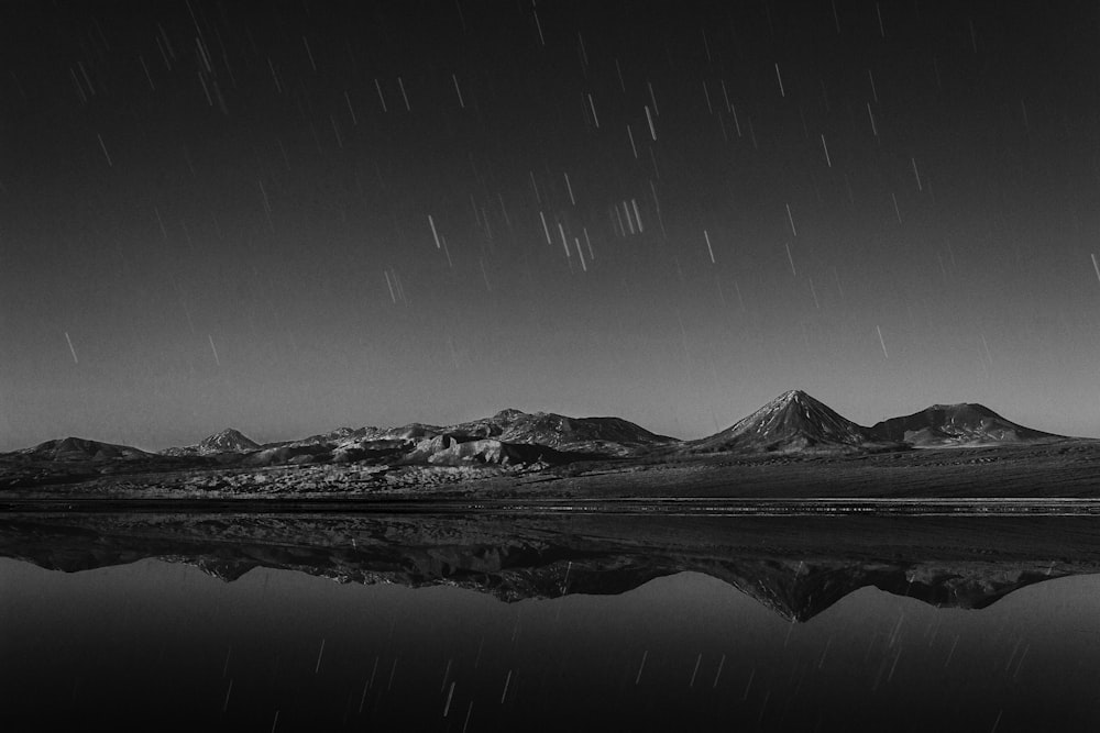 landscape photography of mountains near body of water