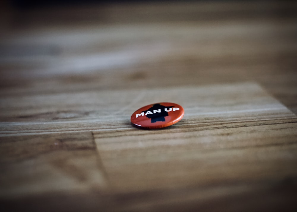 round red and black man up pin back button