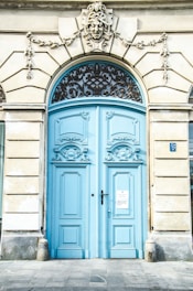 white building with blue wooden doors