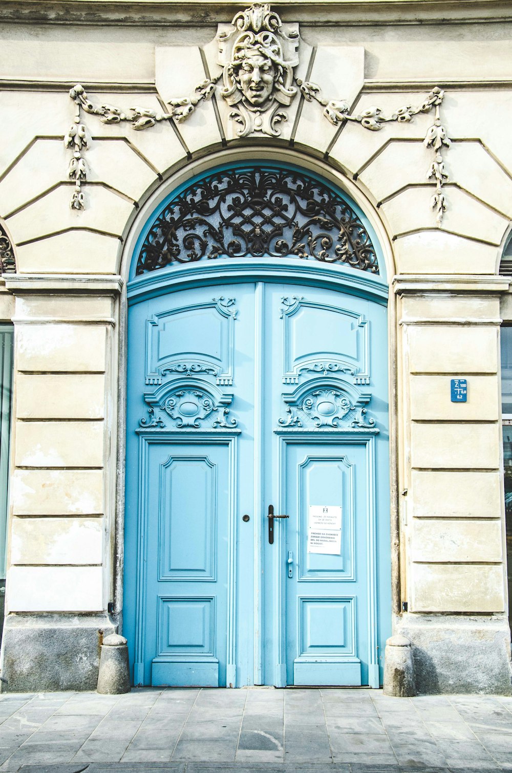 white building with blue wooden doors