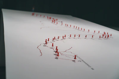 A hand-drawn map pinned on a wall, marked with notes and sketches highlighting urban voids.