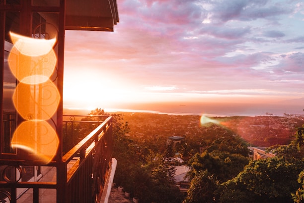 Balcony view overlooking the vibrant cityscape of Cartagena at sunset.