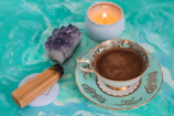 A peaceful corner with candles, crystals, and a cup of herbal tea
