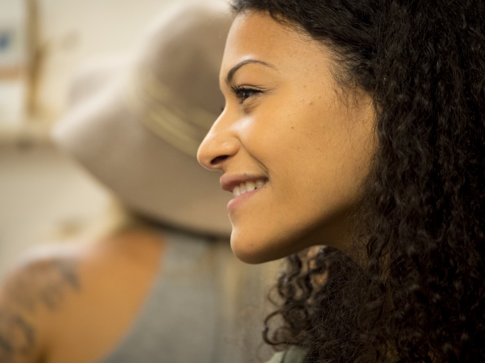 woman smiling while facing left side