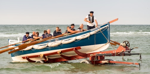 Boat being carefully launched into the water by a professional team