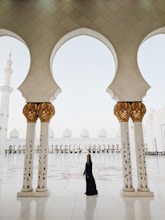 woman standing in middle of two pillars