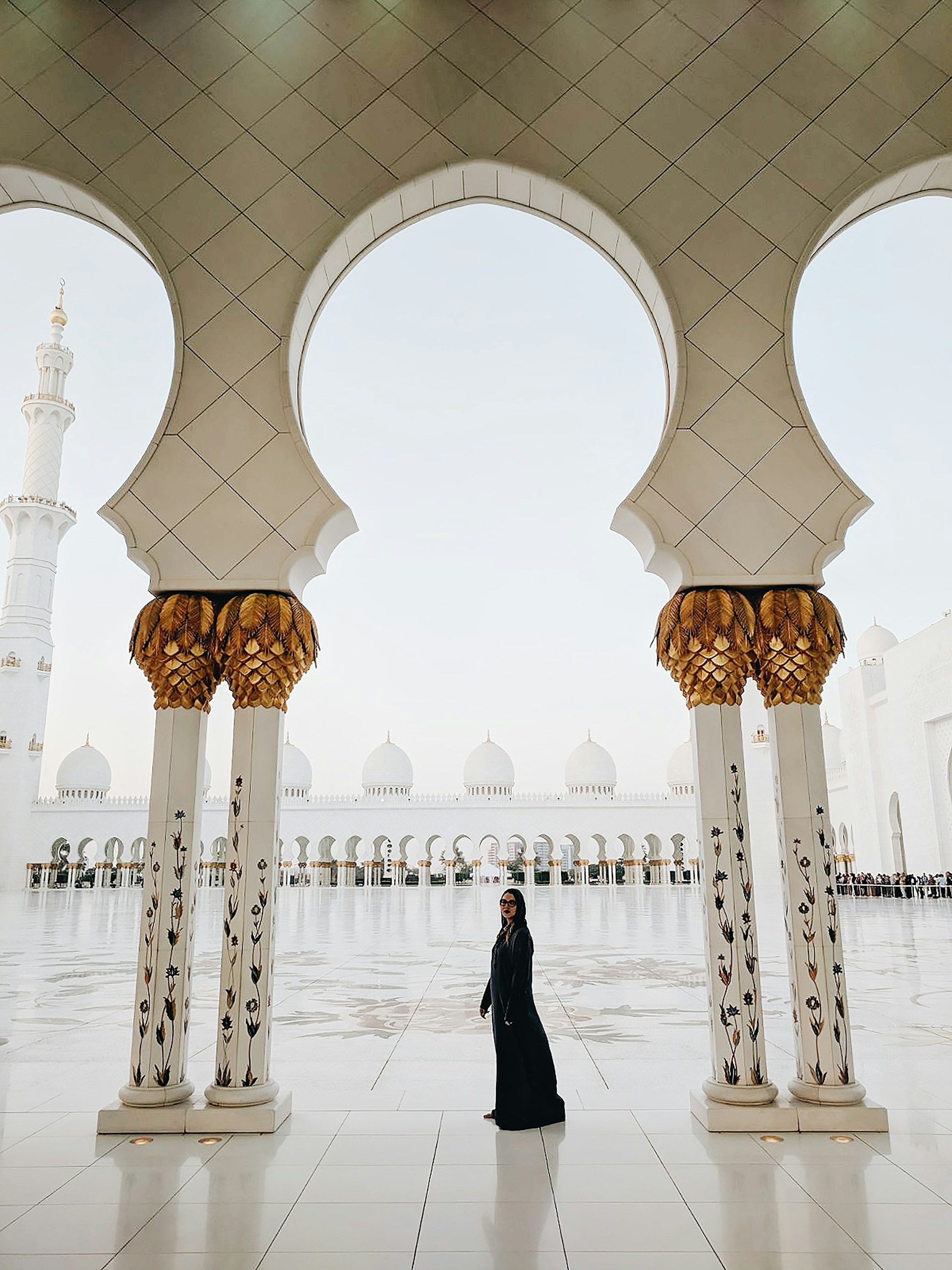 woman standing in middle of two pillars
