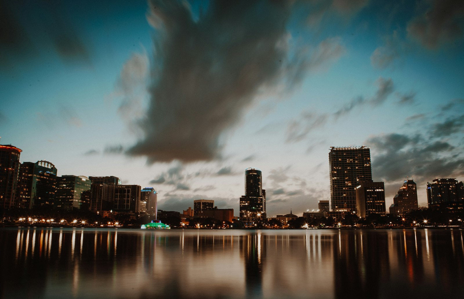 Downtown Orlando skyline at dusk across Lake Eola